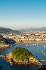 San Sebastian, SPAIN - July 09 2022: High angle view of San Sebastian - Donostia city at sunset. Situated in north of Spain, Basque Country. Famous travel destination. View of La Concha Bay