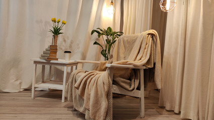 Living room with interior. Wooden armchair, table, vase with tulips in beige light colors and loft style