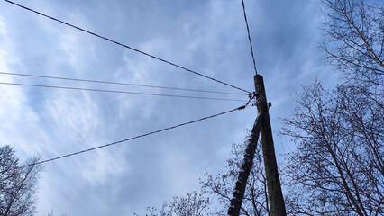 Power electric pole with line wire on blue background close up, photography consisting of power...