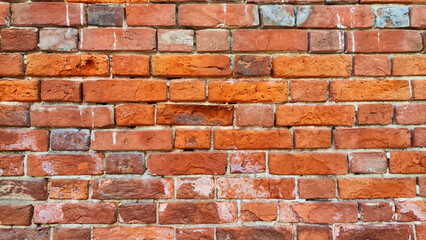 Texture, background and frame made of abstract red brick. Brickwork wall