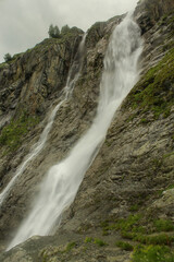 Fototapeta premium Sofia waterfalls in close up in the summer mountains in Arkhyz, stormy sky, copy space for text