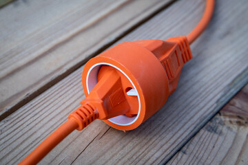 Electric wire, cable or extension cord on wood texture background