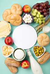 Jewish Shavuot Holiday Card. Dairy Products, Fruits, Cheese, Bread, Milk on Blue Mint Background.