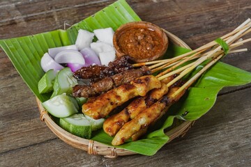 Grilled food chicken and beef satay eaten with peanut sauce is famous Malaysian and Indonesian local dishes