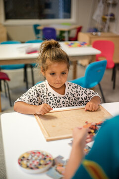Young Aboriginal girl at preschool doing a puzzle
