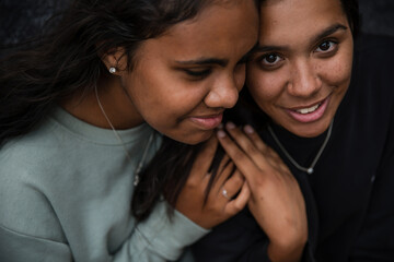 Close-up of two Aboriginal girls hugging
