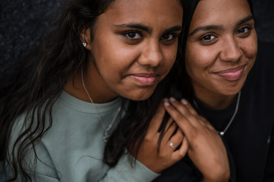 Close-up of two Aboriginal girls hugging