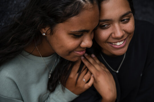 Close-up of two Aboriginal girls hugging