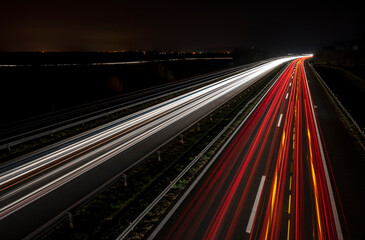 Cars light trails on a straight highway at sunset. Night traffic trails, Motion blur, Night city road with traffic headlight motion.	