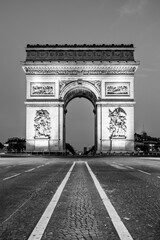 Fototapeta na wymiar Arc de Triomphe de l Etoile at the top of the Champs-Elysees boulevard by night, Paris, France. Black and white image.