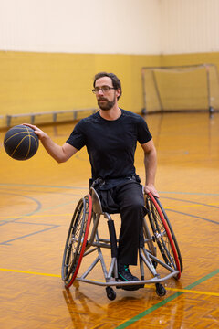 man in black practising wheelchair basketball
