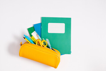 Back to school concept. Flat lay top view on school supplies stack notebook yellow full pencil case...