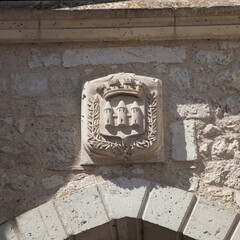 Sculpture au-dessus d'une porte représentant trois tours blason du village de Castillonès en...
