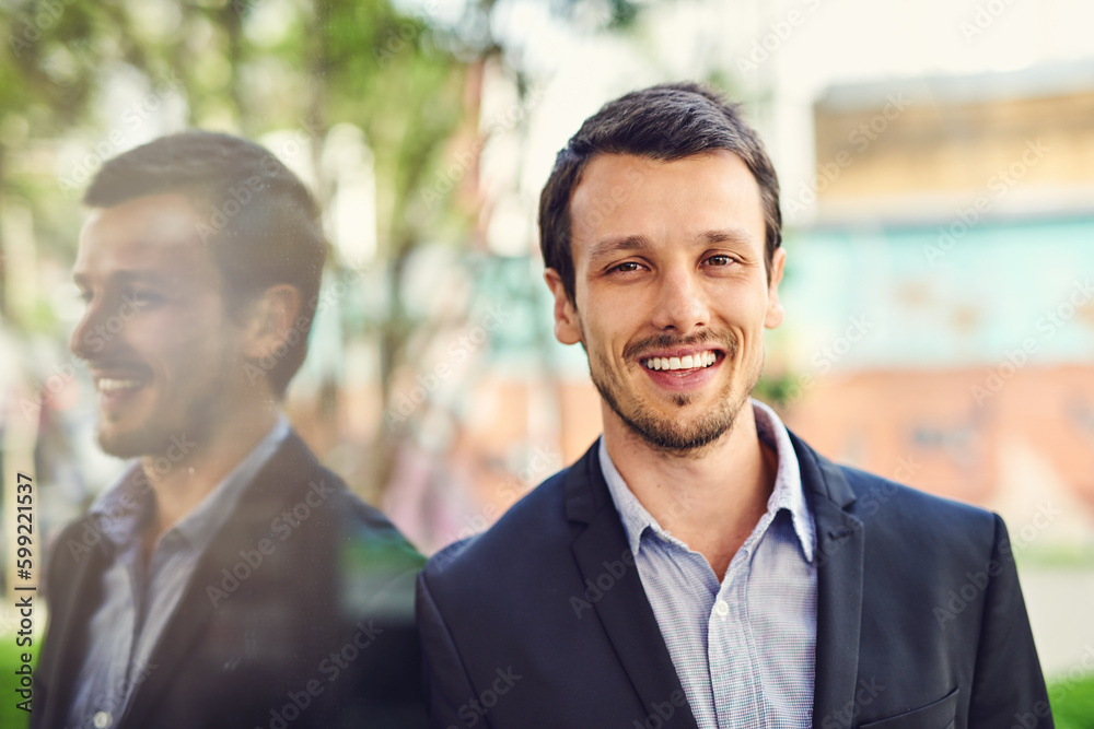 Poster Hes happy that he followed the business path. Portrait of a handsome young businessman outside.