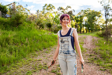 Smiling portrait of teenage young lady in overalls