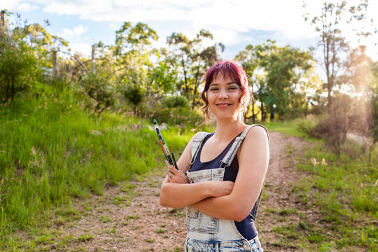 Arms crossed portrait of young artist in nature - Powered by Adobe
