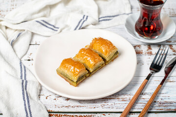 Turkish baklava. Pistachio baklava on wooden background. Traditional Mediterranean cuisine delicacies.