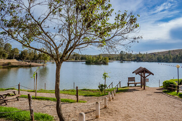 Tree and gravel pathway accessing the Tapada Grande river beach with an island in the middle of the water, Mina de São Domingos - Alentejo PORTUGAL