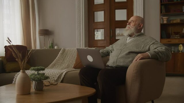 Upset Senior Man, Grandfather Reading Bad News on Laptop