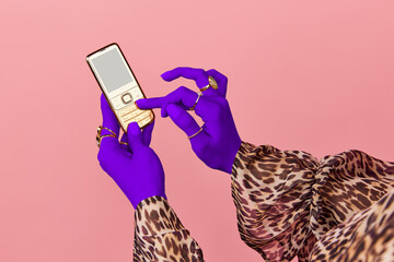 Portrait of female hands of rich woman wearing gold rings holding cell phone with empty screen over...