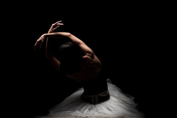 Half silhouette modern ballet dancer. Balerina posing on dark background - obrazy, fototapety, plakaty