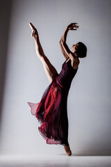 Half silhouette ballerina with a waving red dress. Elegant female ballet dancer. © Nikola Spasenoski