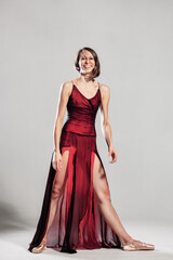 Ballerina with a waving red dress. Elegant female ballet dancer. © Nikola Spasenoski