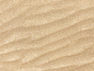 Sand. Texture, surface of sea sand. Natural background. Close-up. Waves of sand. Dunes. Copy space