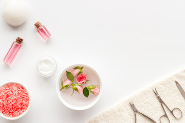 Hands and nails care set with manicure tools and roses flowers.