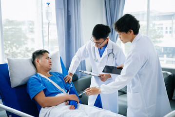 Hospital Ward Male and Male Professional Asian Doctors Talk with a Patient, Give Health Care Advice, Recommend Treatment Plan with Advanced Equipment