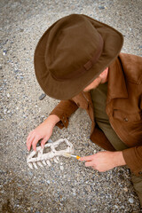paleontologist archaeologist unearths bones of dinosaur skull