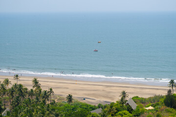 Wide angle shot of Vagator beach as seen from the top of the Chapora Fort at Goa in India. Wide angle shot of beach as seen from above. Blue sea in goa. Summer relaxation background. 