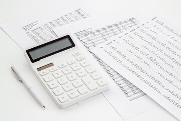 Financial business report preparing with calculator on office table