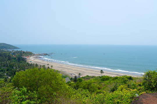 Wide angle shot of Vagator beach as seen from the top of the Chapora Fort at Goa in India. Wide angle shot of beach as seen from above. Blue sea in goa. Summer relaxation background. 