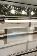 Reflective surfaces of a futuristic induction hob in black. A fuzzy, blurry photograph of a reflection in the surface of a slab.
