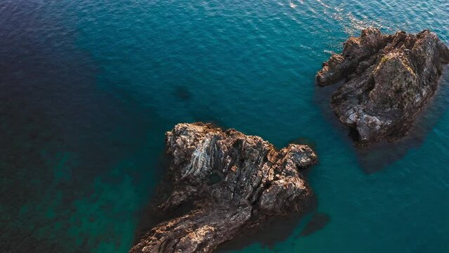 Rocks that are found in the blue and calm sea