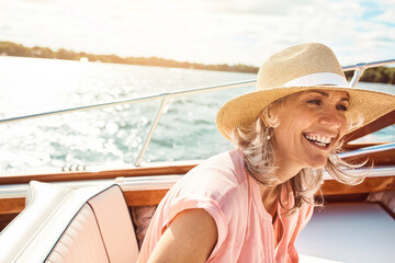 Loving life out here. a mature woman enjoying a relaxing boat ride. - Powered by Adobe