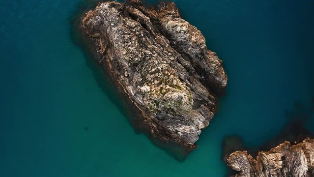 Rocky reefs in the crystal clear sea vertical view