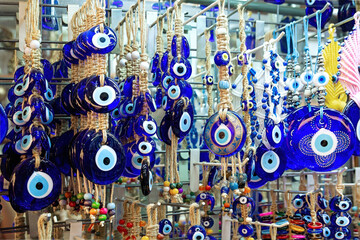 Fototapeta premium Turkish Eye amulet or Nazar Amulet in the Grand Bazaar in Istanbul. The evil eye is a curse or legend believed to be cast by a malevolent glare, usually given to a person when they are unaware.