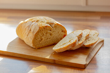 fresh white sliced bread on wooden table in the kitchen