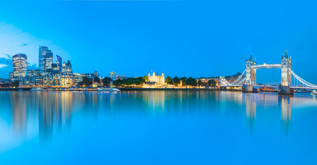 Fototapeta na wymiar Panorama of the Tower Bridge and Tower of London on Thames river at twilight blue hour - London England