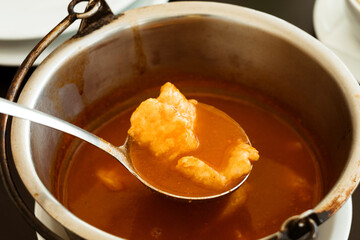 Traditional fish dish from Serbian cuisine - hot and spicy fish paprikaš soup with fresh Danube carp and catfish