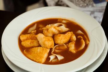 Traditional fish dish from Serbian cuisine - hot and spicy fish paprikaš soup with fresh Danube...