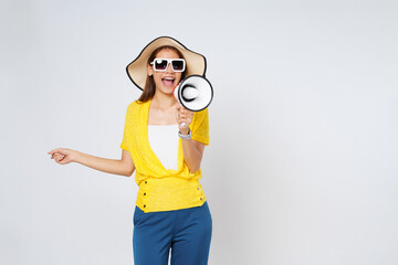 Young woman wearing sun hat, sunglasses and holding megaphone isolated on white background. Lifestyle summer and announce concept.