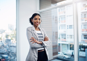 Ill make it happen one way or another. Portrait of a confident young businesswoman working in a...