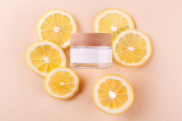 Cosmetic jar with natural energy vitamin skin care. Cosmetic cream qwith slices of lemon on an...