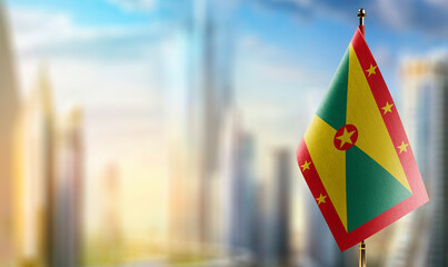 Small flags of the Grenada on an abstract blurry background