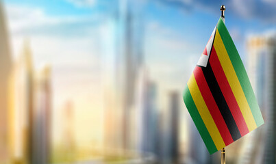 Small flags of the Zimbabwe on an abstract blurry background