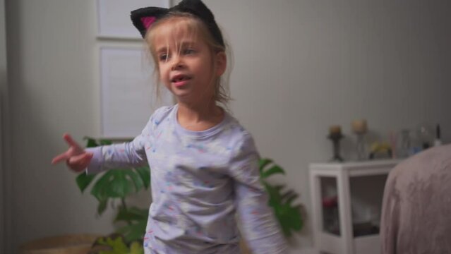 Crazy child dancing at home funny moving Going Mad and Emotional Little Girl. Young Funny Girl Yelling Screaming. Child Scream Loudly. Attention Deficit Hyperactivity Disorder.
