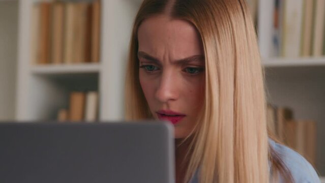 Frowning confused puzzled shocked Caucasian woman looking negative shock to laptop bad result failure business problem online home office frustrated student girl in library computer trouble stressed